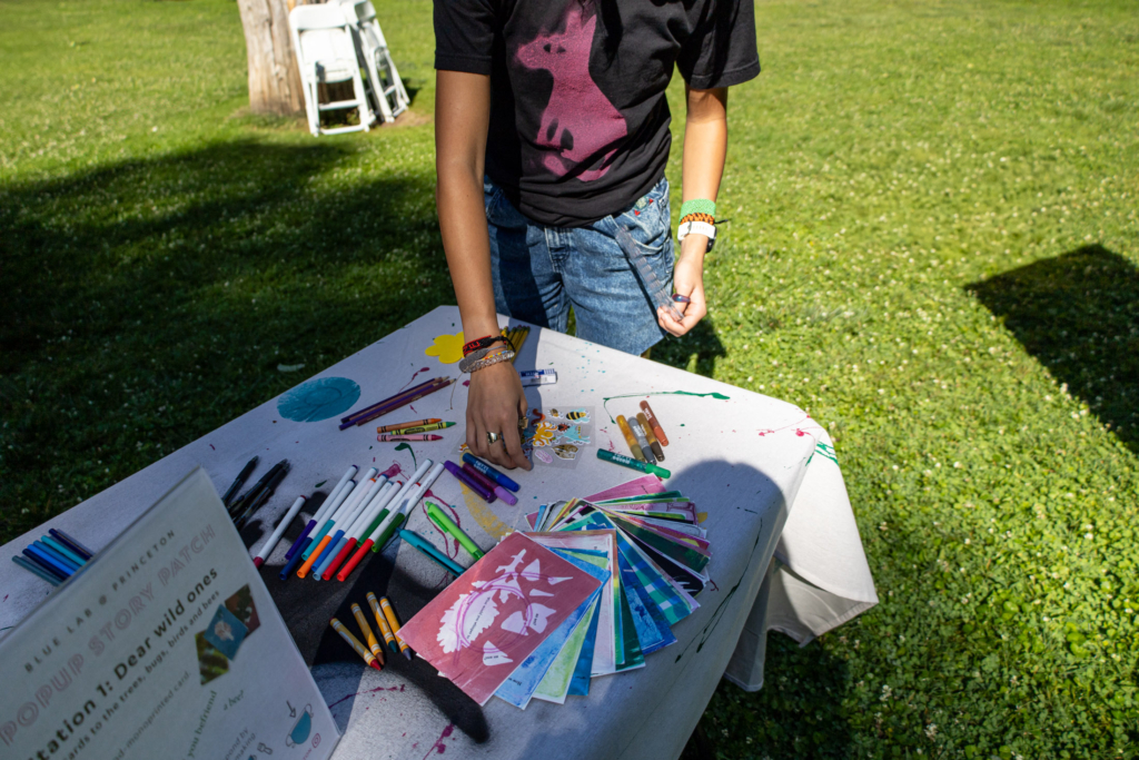 Blue Lab undergraduate student intern Hannah Riggins assembles supplies at the "Dear wild ones" station.