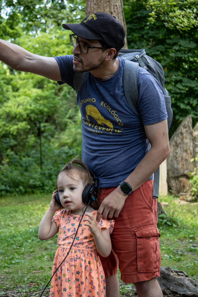 A father and daughter listen to forest sounds at the "Tune into the forest" station.