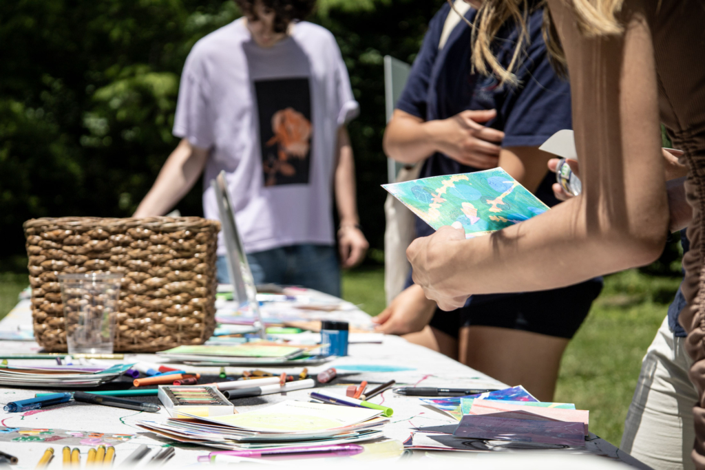 Visitors work on making art from hand-monoprinted cards at the "Dear wild ones" station.