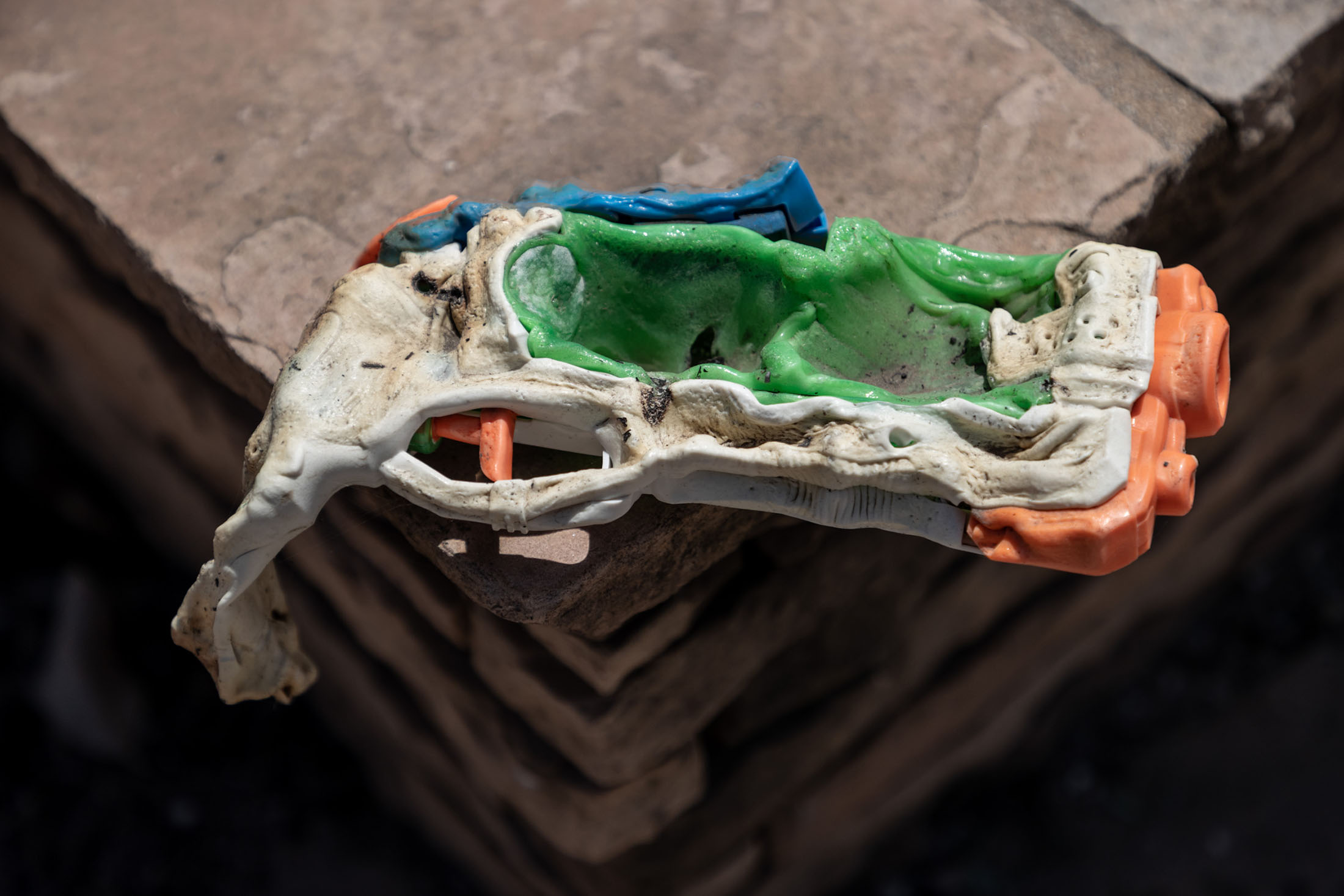 Melted squirtgun on a slab of flagstone