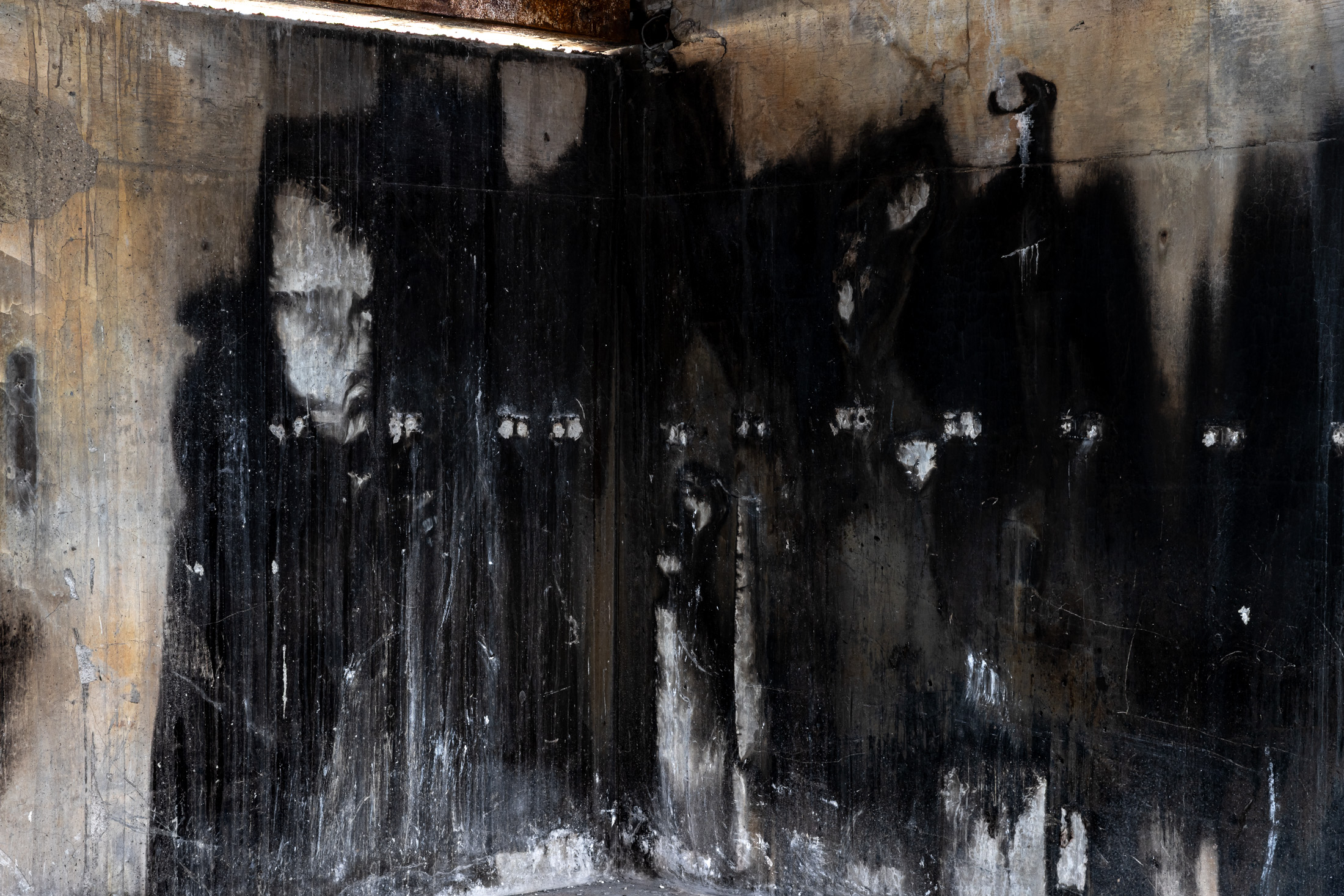 Burn scars left on a cement wall in the interior of a house destroyed by the Palisades Fire